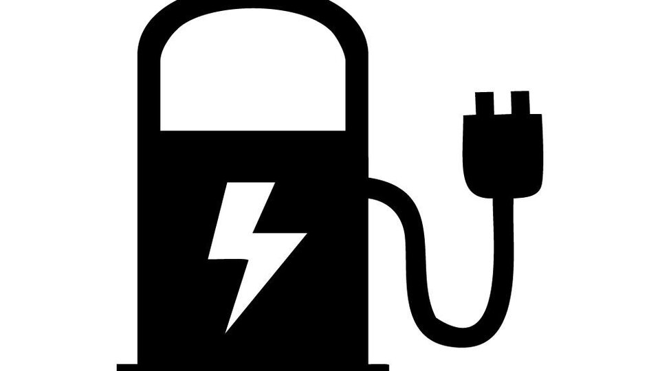 A stylized charging station for electric vehicles with a lightning symbol. The image shows an electrical outlet for charging.