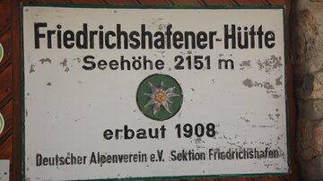 A sign of the Friedrichshafener Hut at an altitude of 2151 m. It was built in 1908 and belongs to the German Alpine Club.