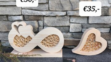Two decorative wooden elements in the shape of a heart and an infinity symbol. They are available as gifts, priced at €35 and €50.