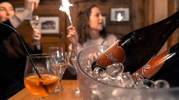 A festive celebration with sparkling wine and glittering sparklers. The ambiance is cozy and appealing.