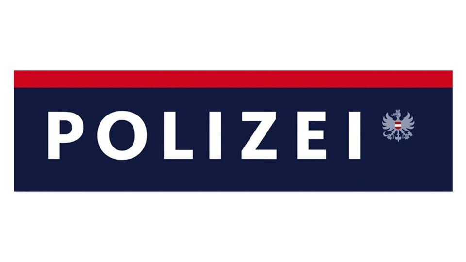 A sign with the word "POLICE" in large letters. Below it is a coat of arms associated with the police.