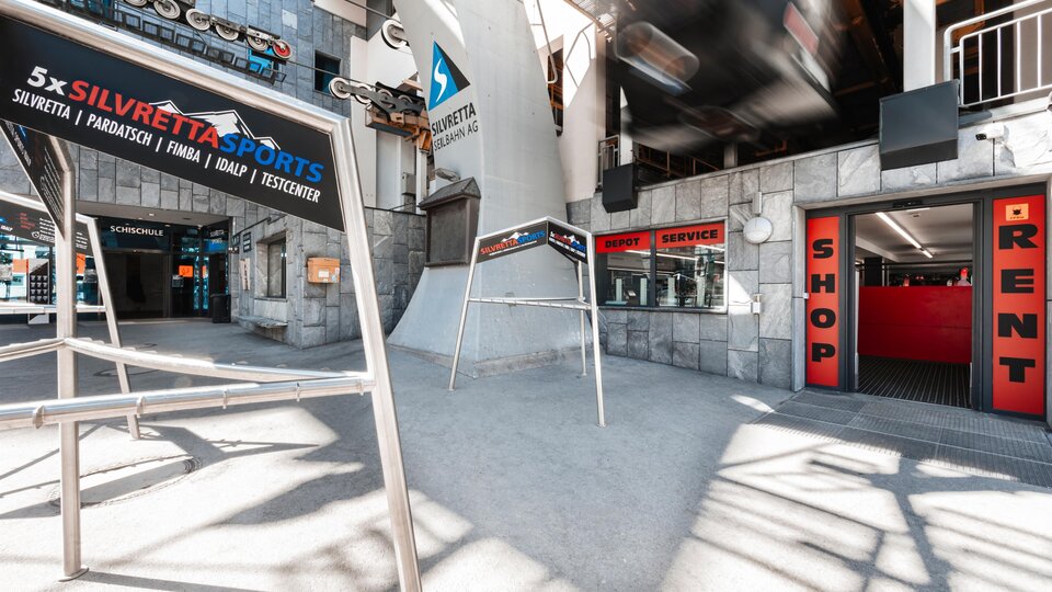 A modern sports area with signs for rental and shop. The environment is bright and invites activities.