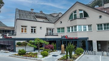 A modern building with a restaurant area and well-maintained garden facilities. The architecture is appealing and the surroundings invite you to linger.