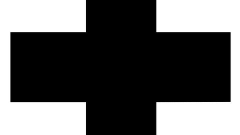 A black cross on a white background. It often symbolizes medical assistance or emergency services.