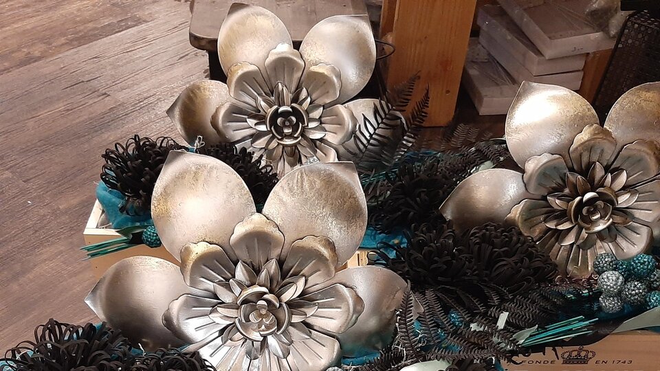 Two decorative boxes with artistic floral arrangements in silver and black. The flowers are arranged in various shapes, giving an elegant look.