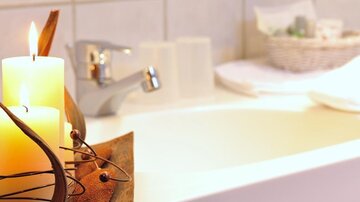 A relaxing bathtub with candles and soft towels. The atmosphere is calm and inviting.